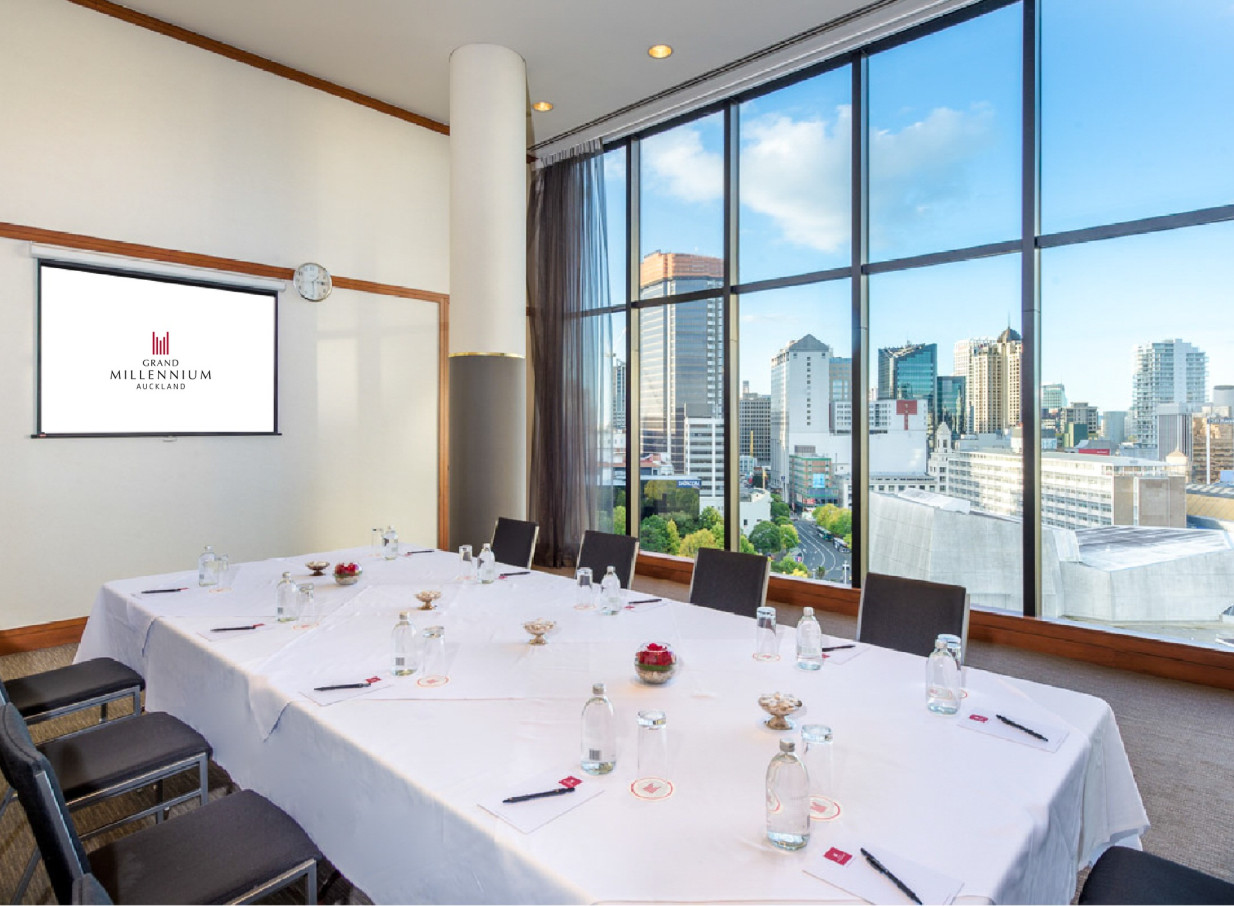 This modern meeting room at Grand Millennium Auckland features abundant natural light and panoramic city views.