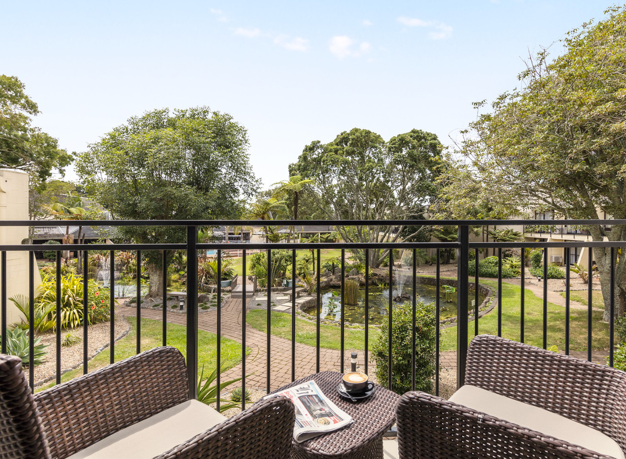 A private balcony at the Holiday Inn Auckland Airport offers a tranquil view of its contemporary Pacific-inspired subtropical gardens and pond.