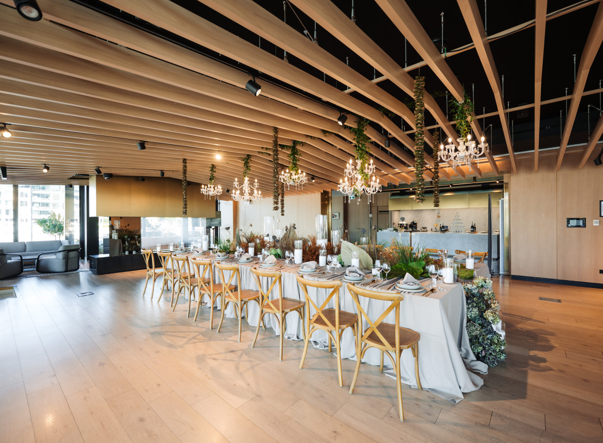 Park Hyatt Auckland's elegant private dining room features natural timber architecture and sparkling chandeliers.
