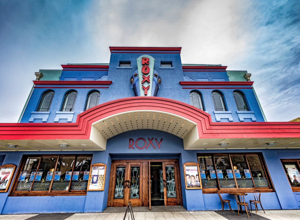 The Roxy, Wellington's vibrant Art Deco cinema, showcases a striking blue facade with red accents and a classic marquee.