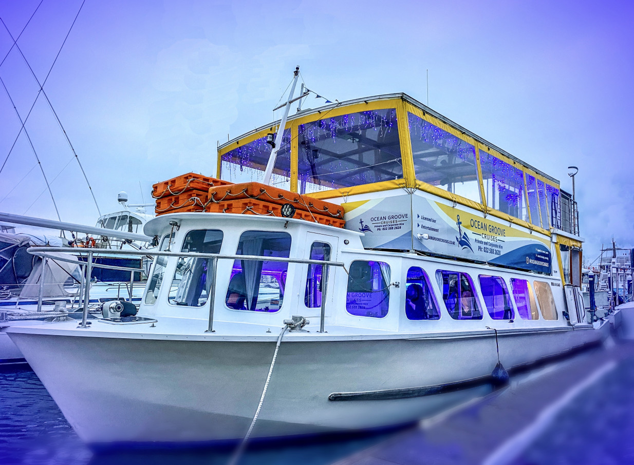 Ocean Groove Cruises, an Auckland modern party boat, features blue-lit decks for unique events on the water.