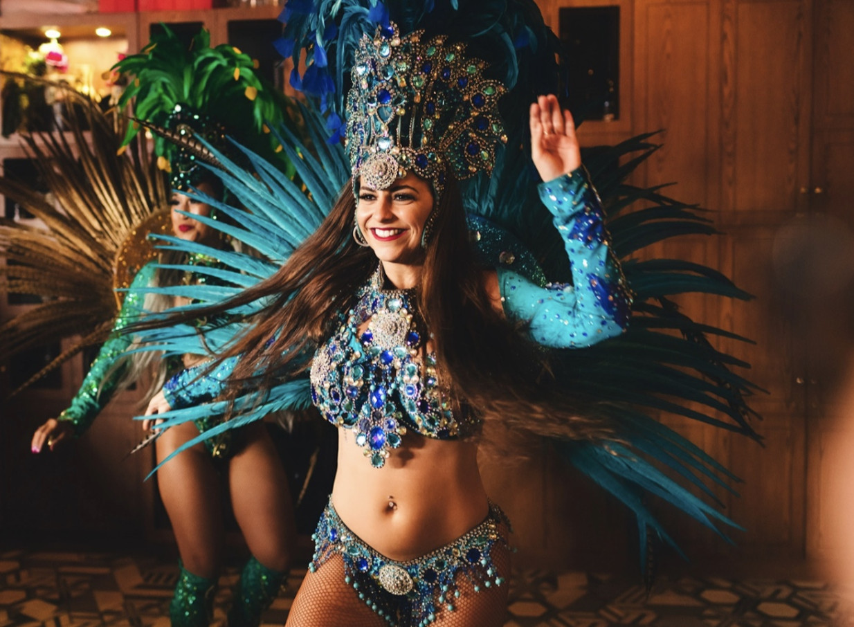 Carnival dancers entertain guests on a modern, Mediterranean-inspired themed cruise with Ocean Groove Cruises, Auckland.