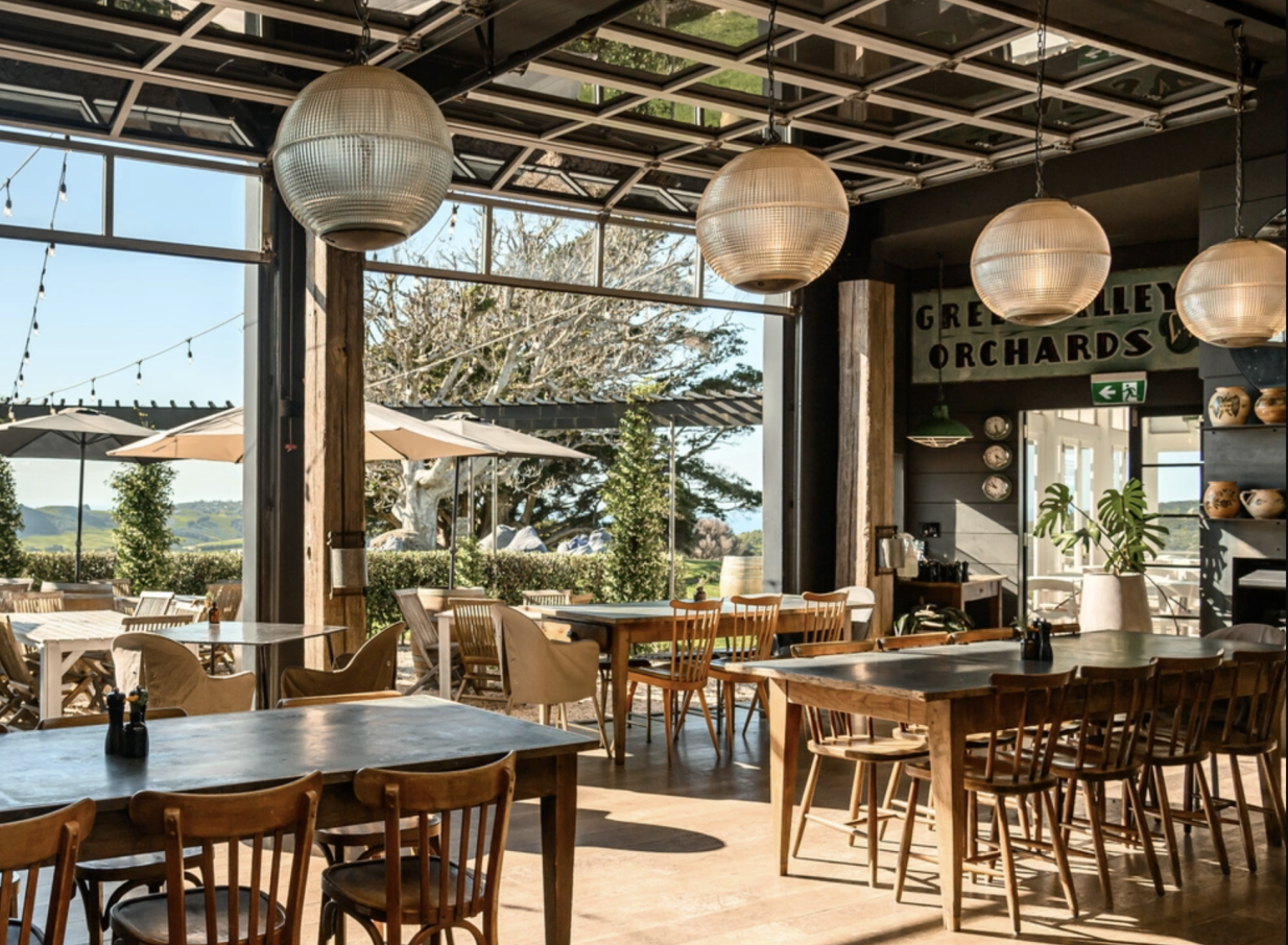 Batch Winery on Waiheke Island offers a bright, airy dining area with panoramic vineyard views from its glass-walled restaurant.