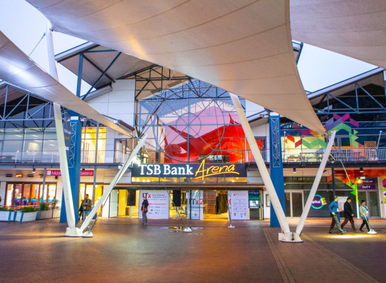 The TSB Arena in Wellington features a modern waterfront event space with striking white sail-like canopies and a glass facade.