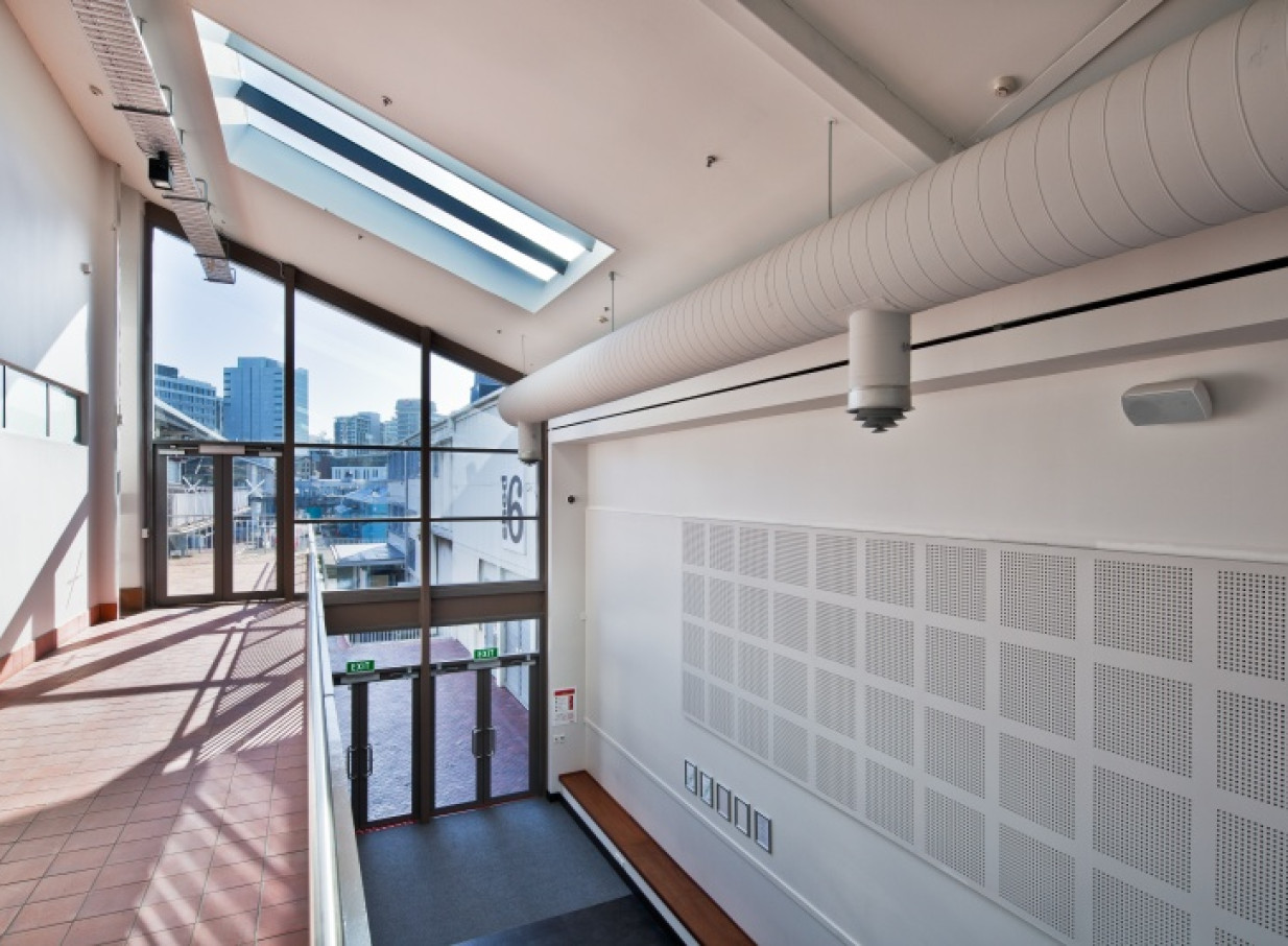 Shed 6, Wellington, features a contemporary, light-filled arcade with large windows, skylights, and exposed industrial ductwork.