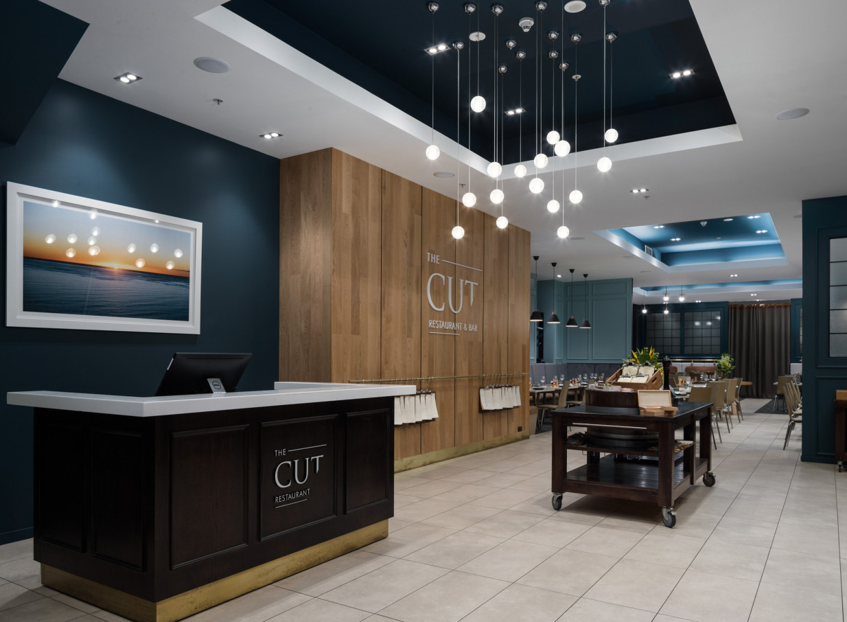 A contemporary reception area and entrance to The CUT Restaurant & Bar at Rydges Auckland.