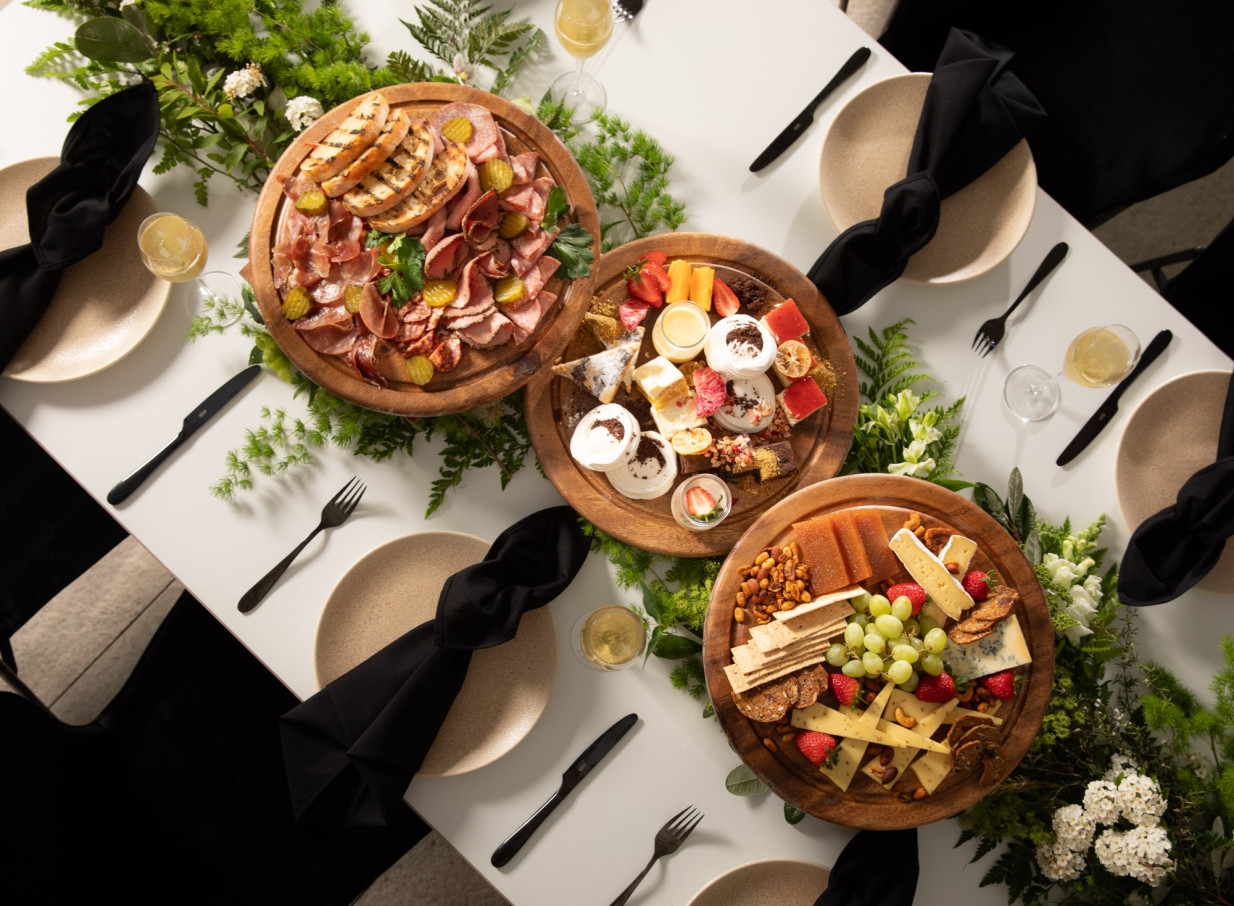 A sophisticated dining setup with exquisite sharing platters, showcasing Rydges Auckland's contemporary elegance.