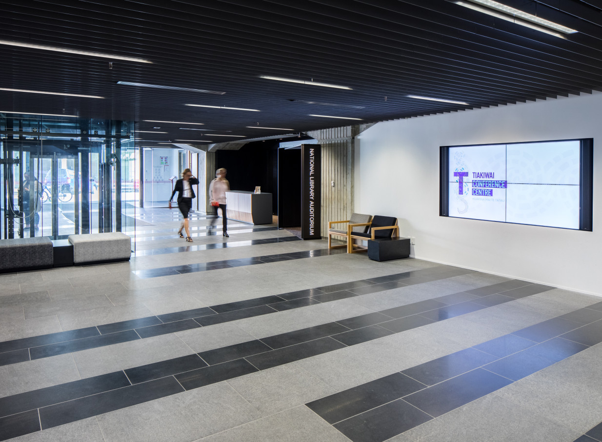 A modern foyer space with people walking at the Tiakiwai Conference Centre in Wellington.