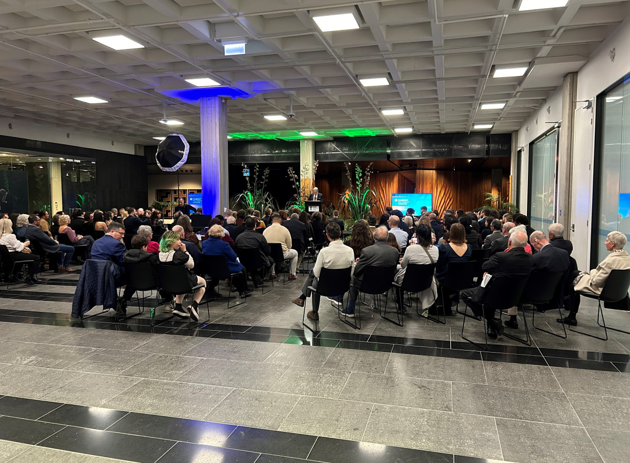 Attendees observe a speaker at a podium in the award-winning, modern auditorium of Tiakiwai Conference Centre, Wellington.