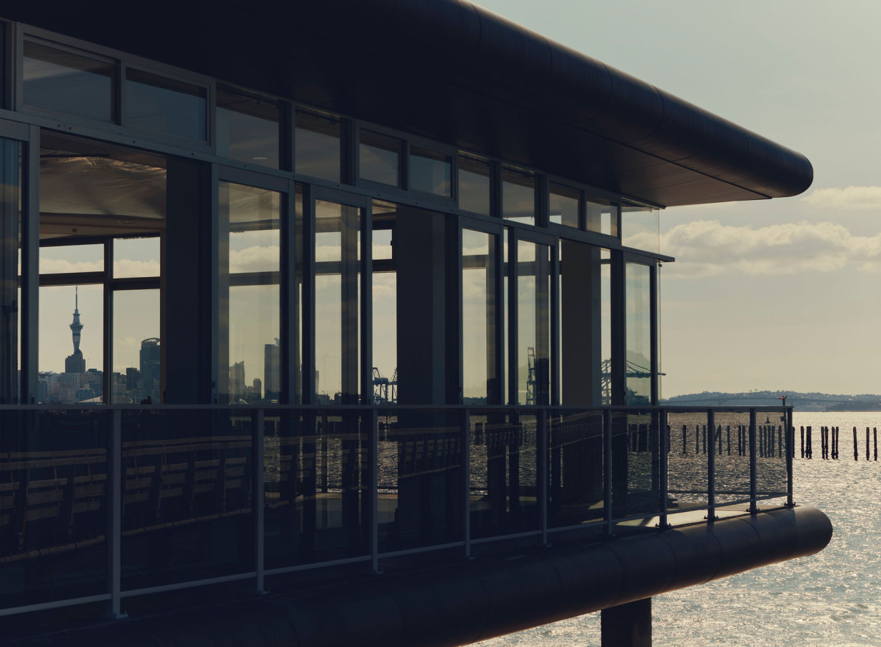 OKAHU, a modern waterfront venue in Auckland, features panoramic glass windows with stunning city and harbour views.