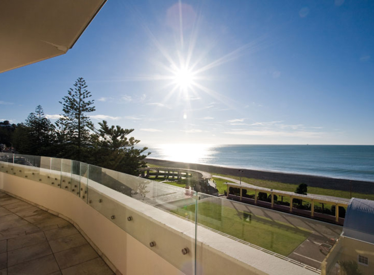 The Art Deco Dome in Hawke's Bay offers a stunning ocean view from its elegant balcony.
