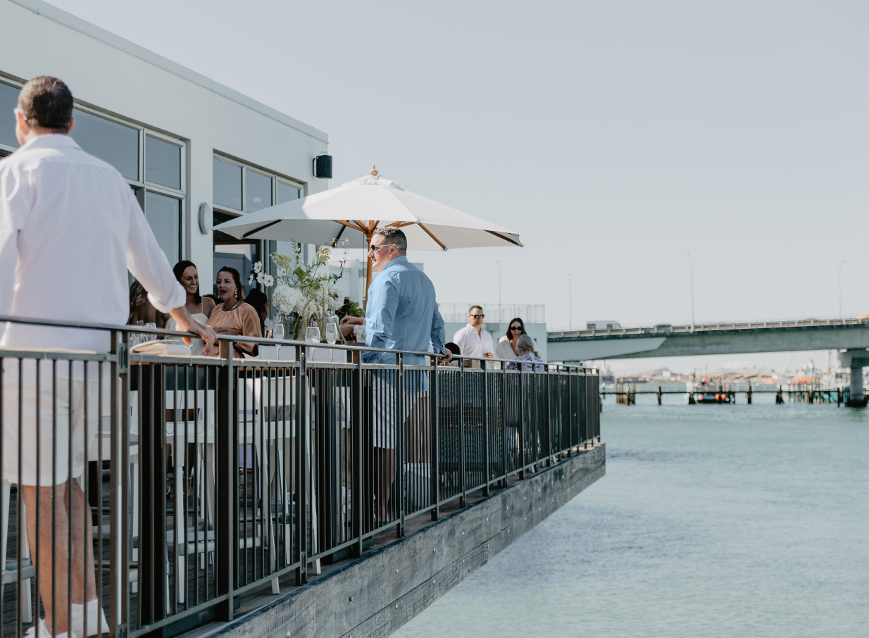 Trinity Wharf, Tauranga's coastal-styled over-water hotel, offers a spacious outdoor terrace for relaxed gatherings.