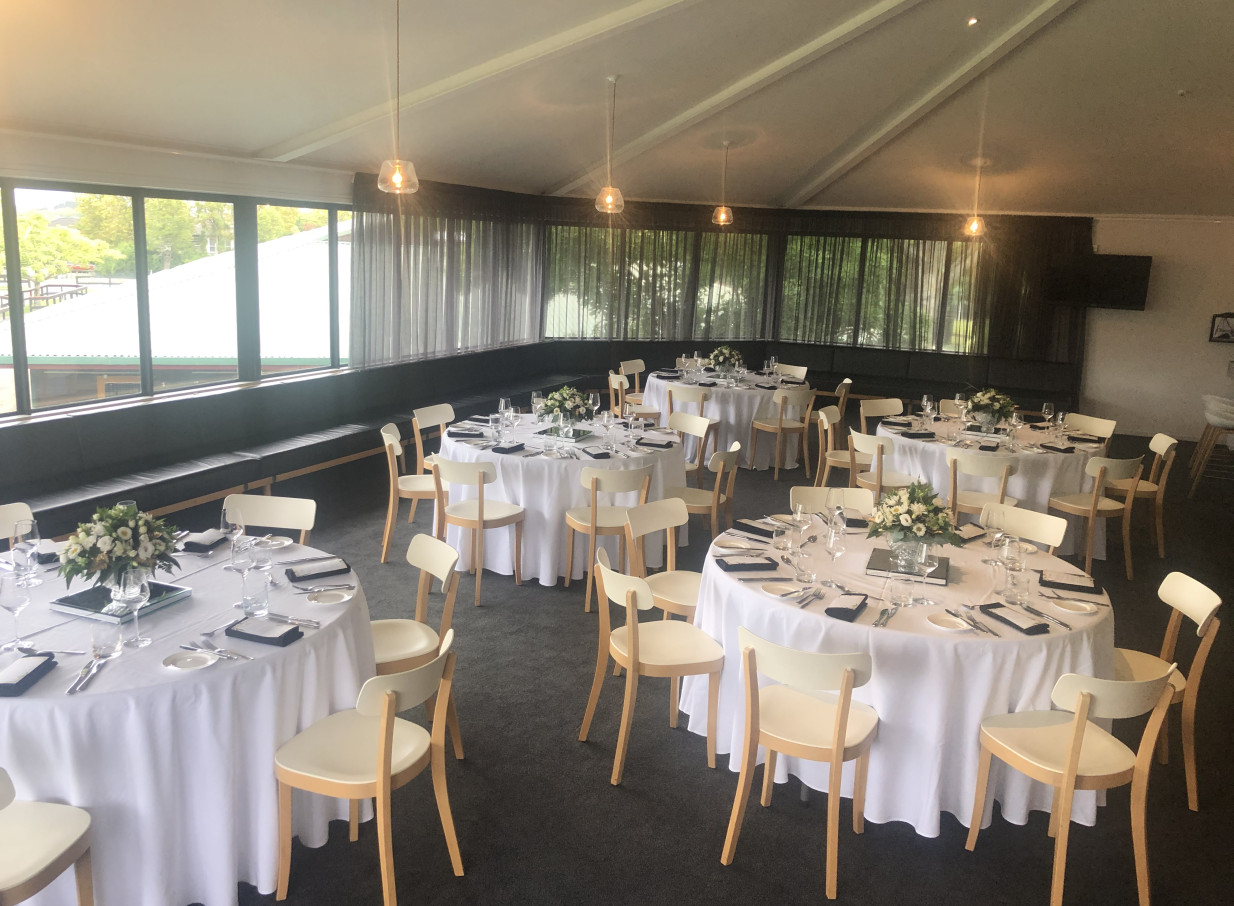Karaka Pavilion, Auckland, features a bright, contemporary dining room with high ceilings and garden views, elegantly set for dining.