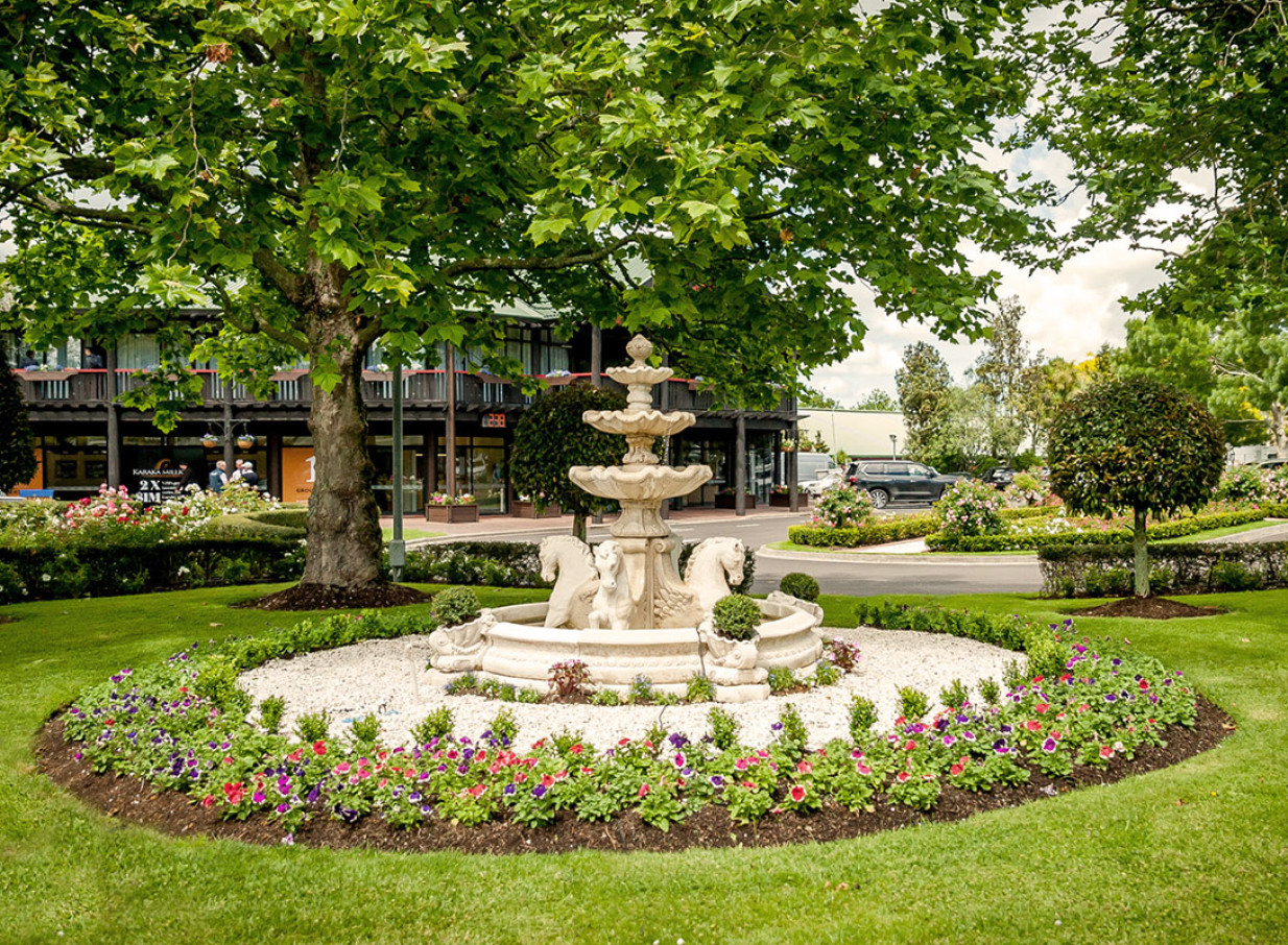 A classic fountain with horse sculptures in the extensively manicured gardens of Karaka Pavilion, Auckland.