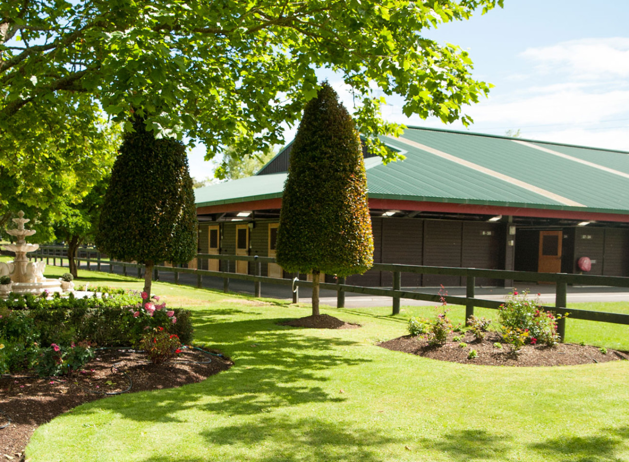Manicured gardens and classic stable buildings at Karaka Pavilion, Auckland, provide an elegant outdoor setting.