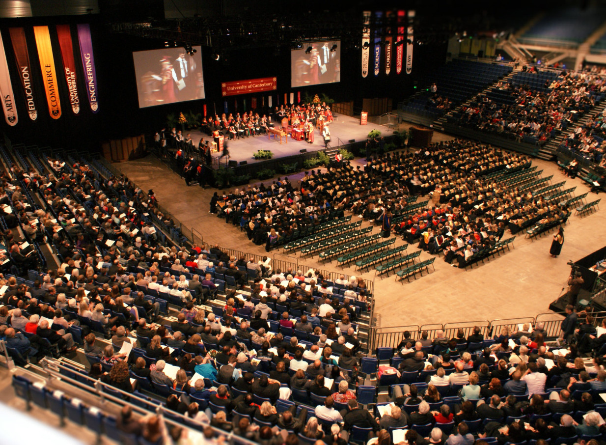 A University of Canterbury graduation ceremony fills the expansive, modern Wolfbrook Arena in Christchurch.