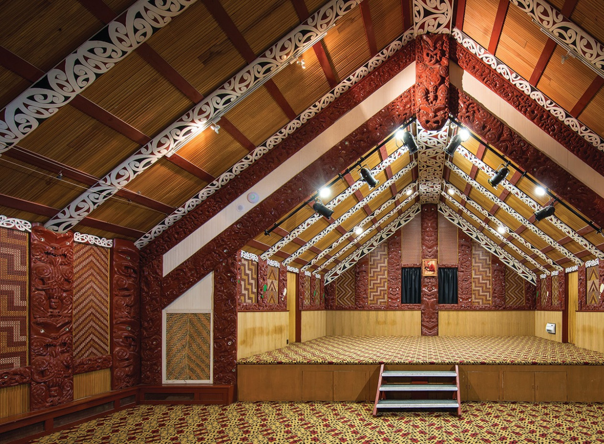 Te Puia, Rotorua, offers a cultural performance space within its richly carved traditional Māori meeting house.